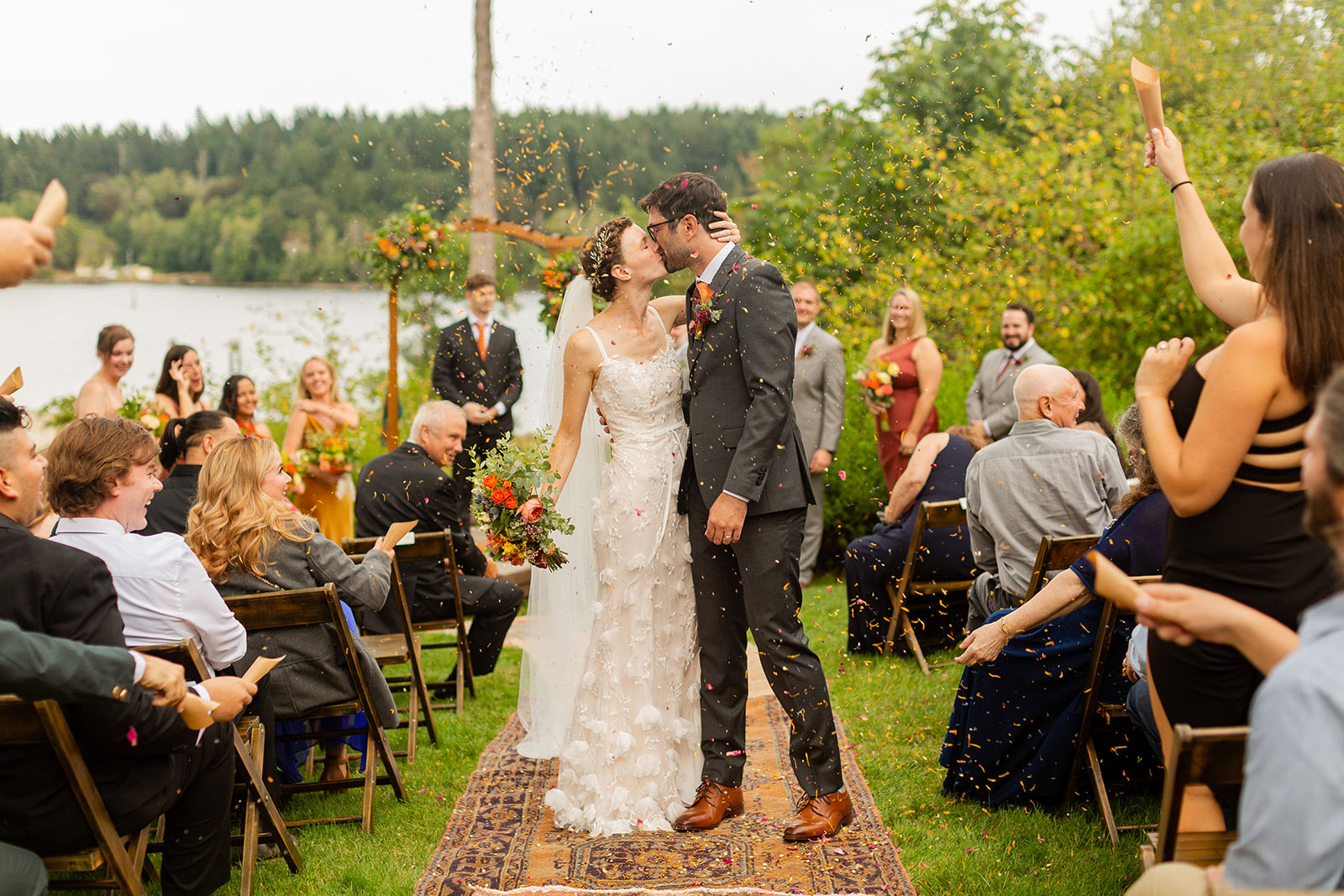 bride and groom kissing down the isle